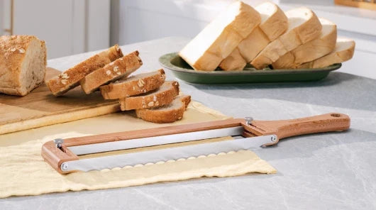 Walnut adjustable bread knife with a guide cutting even homemade bread slices