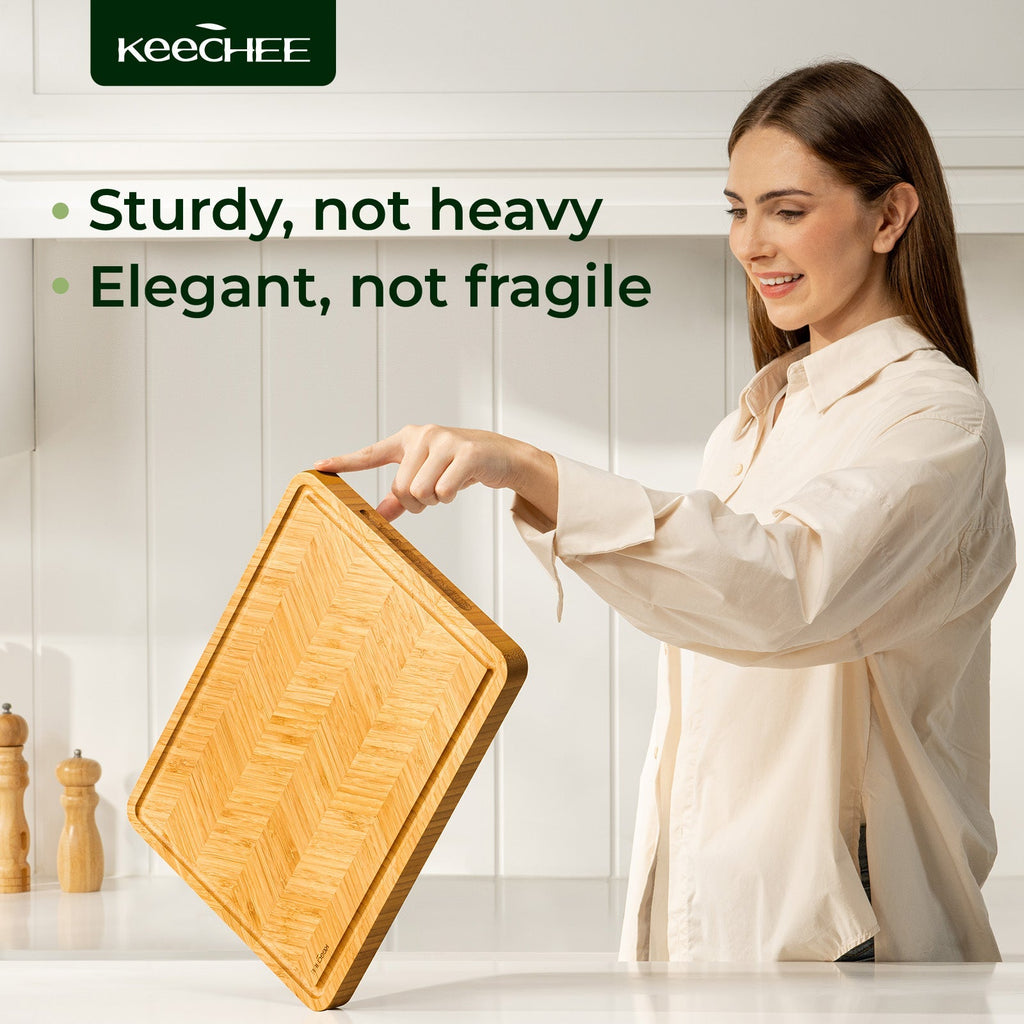 Woman holding an Atelier herringbone bamboo cutting board