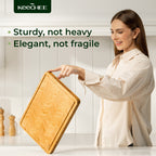 Woman holding an Atelier herringbone bamboo cutting board