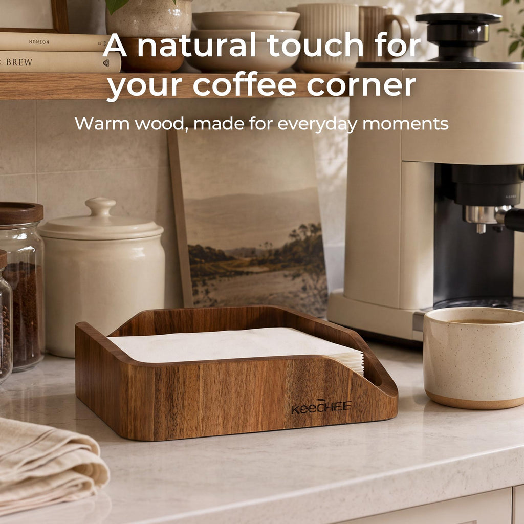 Acacia wood napkin holder with paper napkins beside a coffee machine and ceramic mug